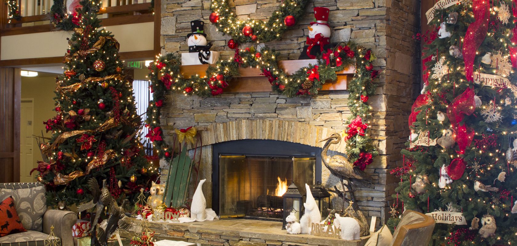 A Fire Place Sitting In A Living Room With A Christmas Tree