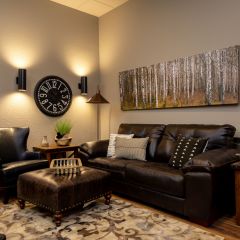 A Living Room Filled With Furniture And A Clock